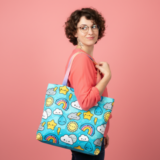 Woman holding a colorful tote bag with cartoon designs on a pink background