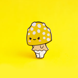 a yellow and white mushroom with polka dots on it